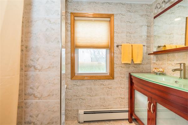 1 4th Street Lexington, MA 02420 - Photo 12 of 22 a bathroom with a sink a vanity and a shower
