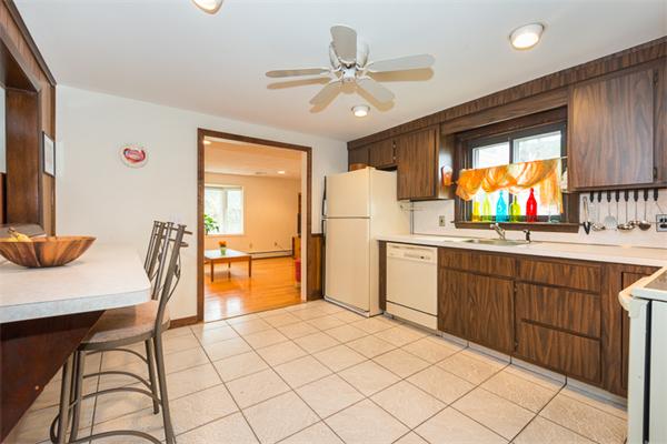 1 4th Street Lexington, MA 02420 - Photo 10 of 22 a kitchen with stainless steel appliances kitchen island granite countertop a table chairs in it and wooden floors