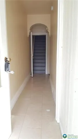 a view of room with stairs and a hallway