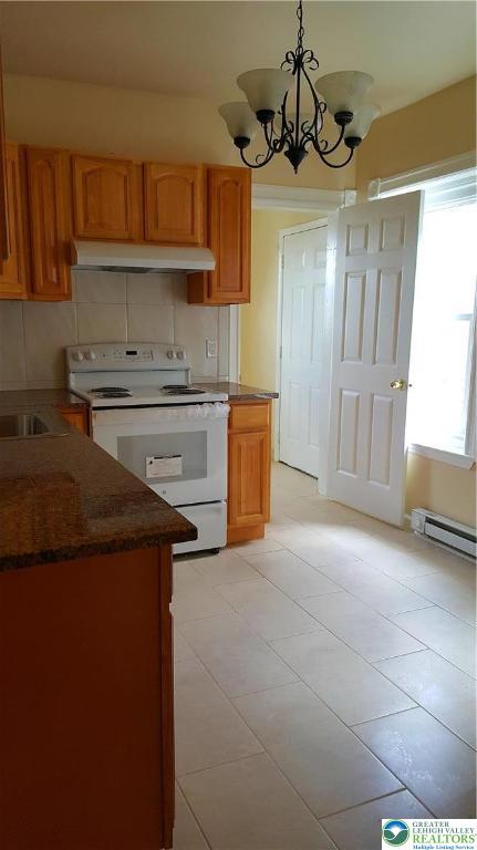 541 Washington Street, Unit 2 Allentown, PA 18102 - Photo 3 of 7 a kitchen with a stove a sink and a refrigerator