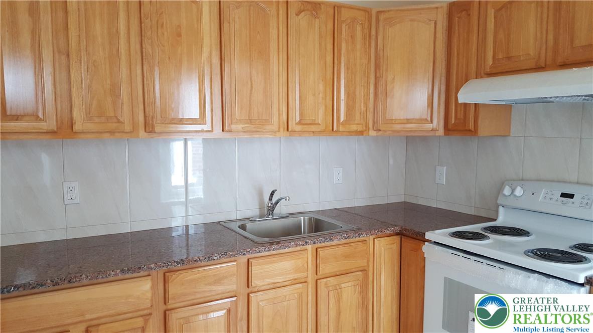 541 Washington Street, Unit 2 Allentown, PA 18102 - Photo 4 of 7 a kitchen with granite countertop a sink a stove and dishwasher