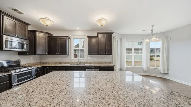 a view of a hallway with wooden floor and entryway