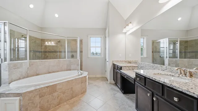 an empty room with chandelier fan and windows