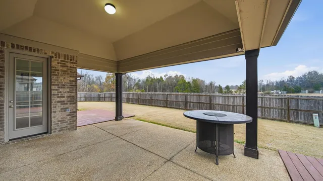 a view of a chairs and table in the patio