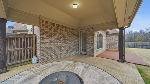 a view of an empty room with floor to ceiling window