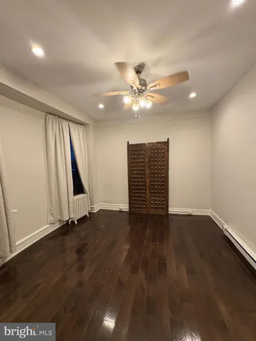 an empty room with wooden floor and window