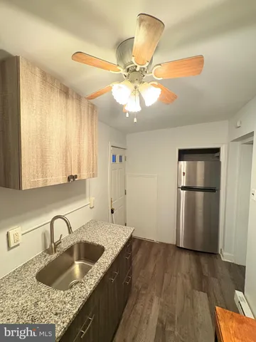 a kitchen with a sink cabinets and stainless steel appliances