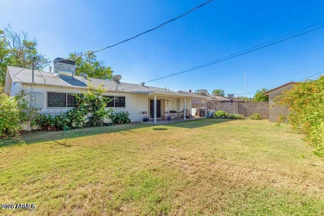 a house view with swimming pool in front of it