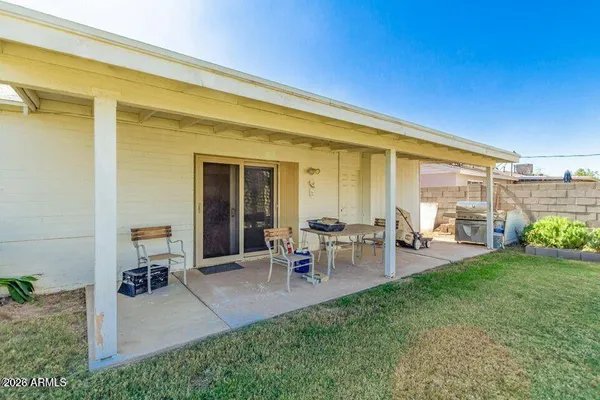 a view of a backyard with sitting area furniture and garden