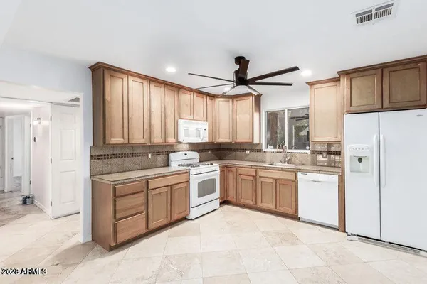 a kitchen with a stove top oven sink and refrigerator