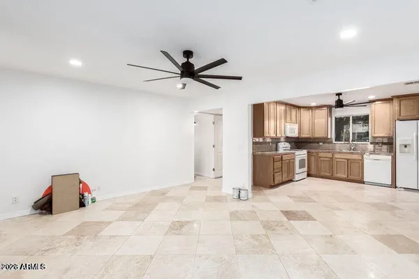 a kitchen with stainless steel appliances cabinets a sink and a refrigerator