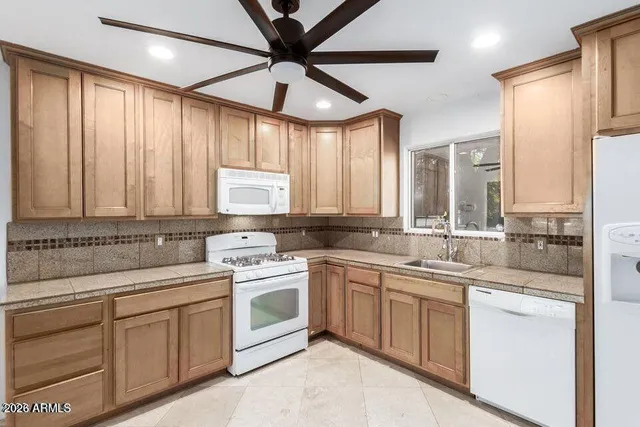 a kitchen with a white cabinets and sink