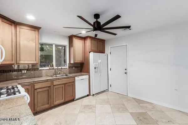 a view of a kitchen with a sink stainless steel appliances and cabinets