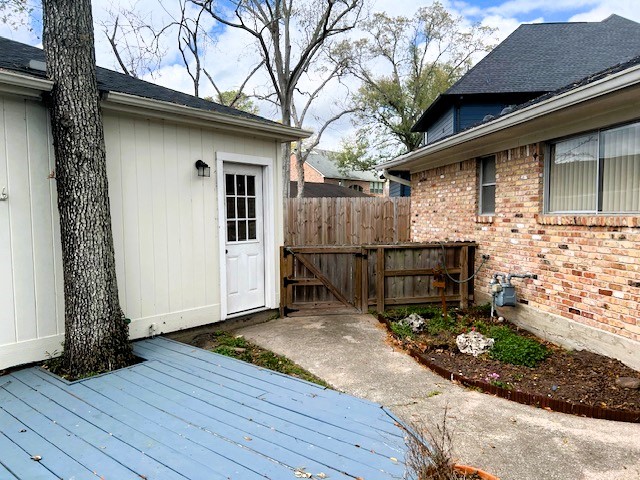 8639 Cedarbrake Drive Spring Valley Village, TX 77055 - Photo 21 of 26 Enjoy the cozy charm of this backyard with a delightful deck and convenient garage access, all while maintaining just the right amount of privacy from the driveway.