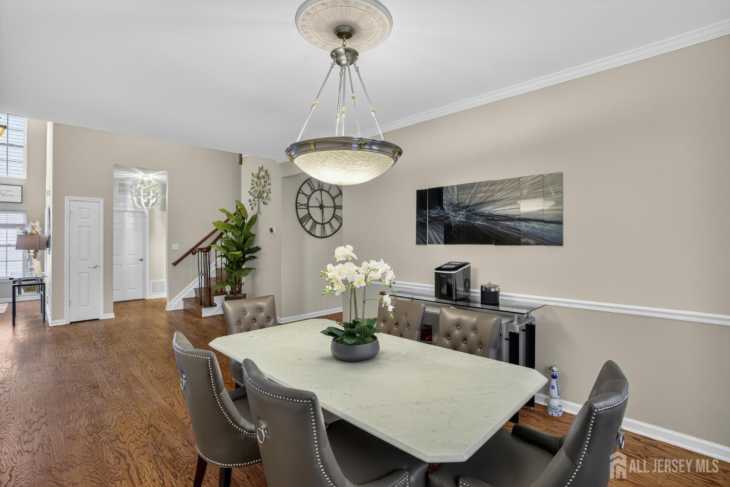 6 George Russell Way Clifton, NJ 07013 - Photo 12 of 45 a view of a dining room with furniture a chandelier and wooden floor