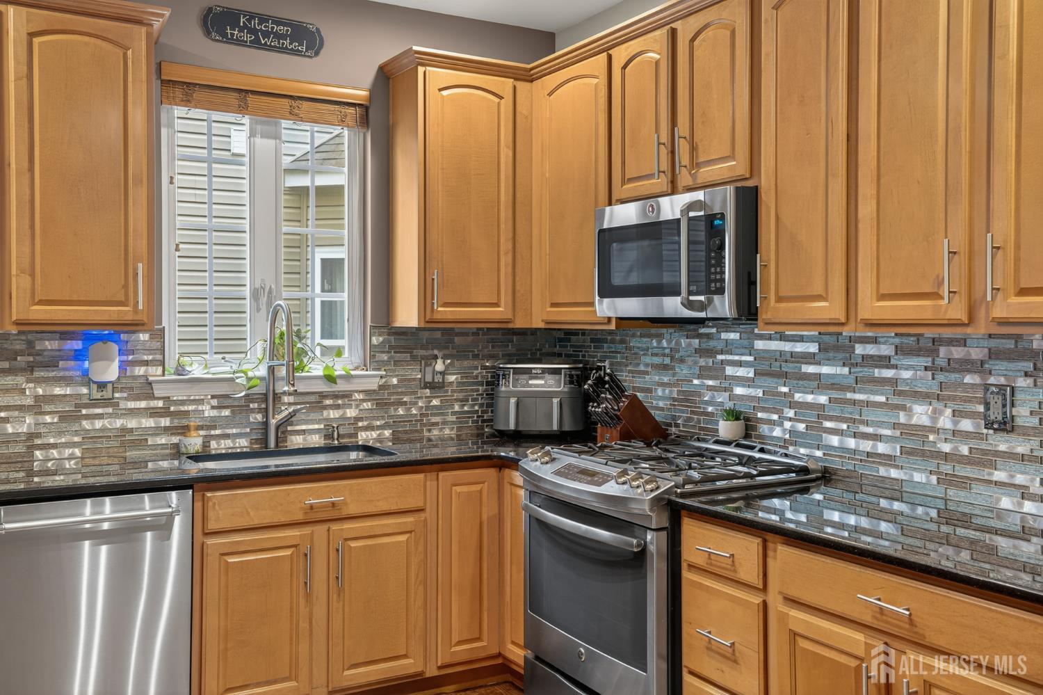 6 George Russell Way Clifton, NJ 07013 - Photo 15 of 45 a kitchen with stainless steel appliances granite countertop a sink a stove and a microwave