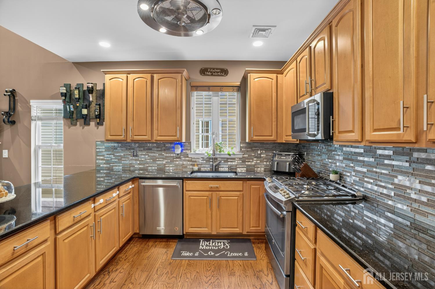 6 George Russell Way Clifton, NJ 07013 - Photo 17 of 45 a kitchen with stainless steel appliances granite countertop a sink a stove and a wooden cabinets