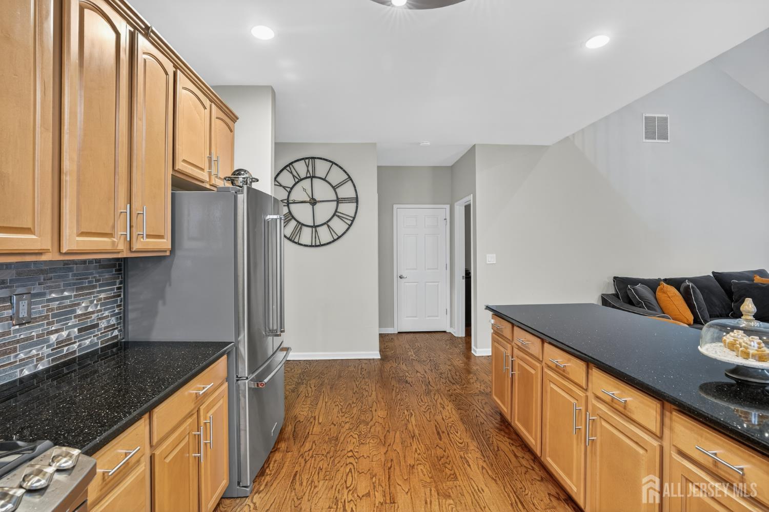 6 George Russell Way Clifton, NJ 07013 - Photo 18 of 45 a kitchen with granite countertop a sink a stove top oven a clock and cabinets