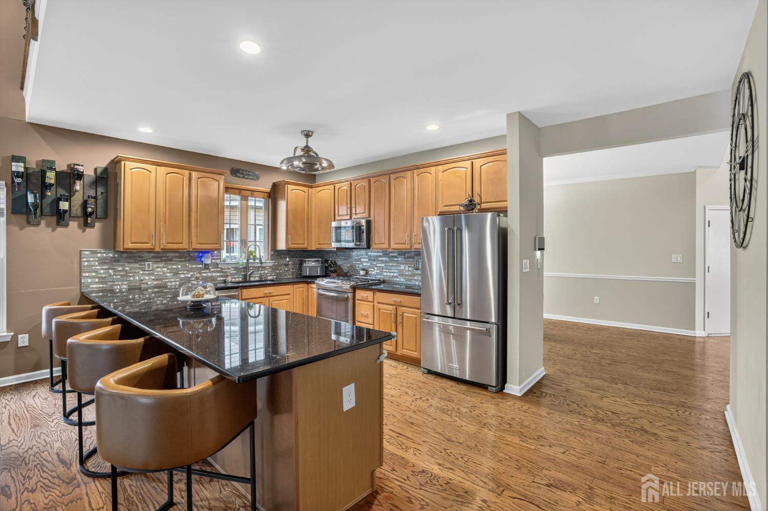6 George Russell Way Clifton, NJ 07013 - Photo 20 of 45 a kitchen with kitchen island a counter top space a sink stainless steel appliances and cabinets