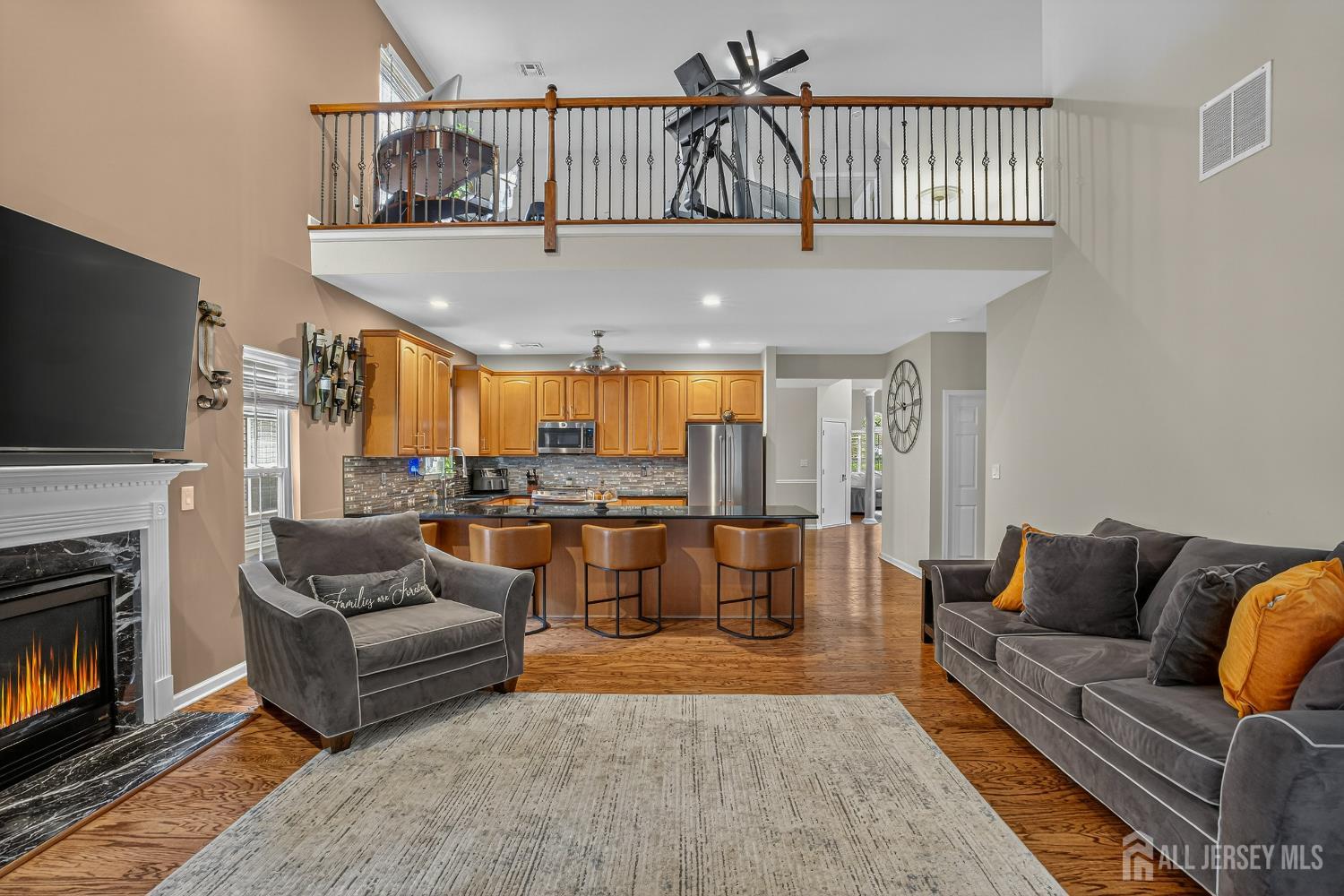 6 George Russell Way Clifton, NJ 07013 - Photo 21 of 45 a living room with furniture a fireplace and a flat screen tv
