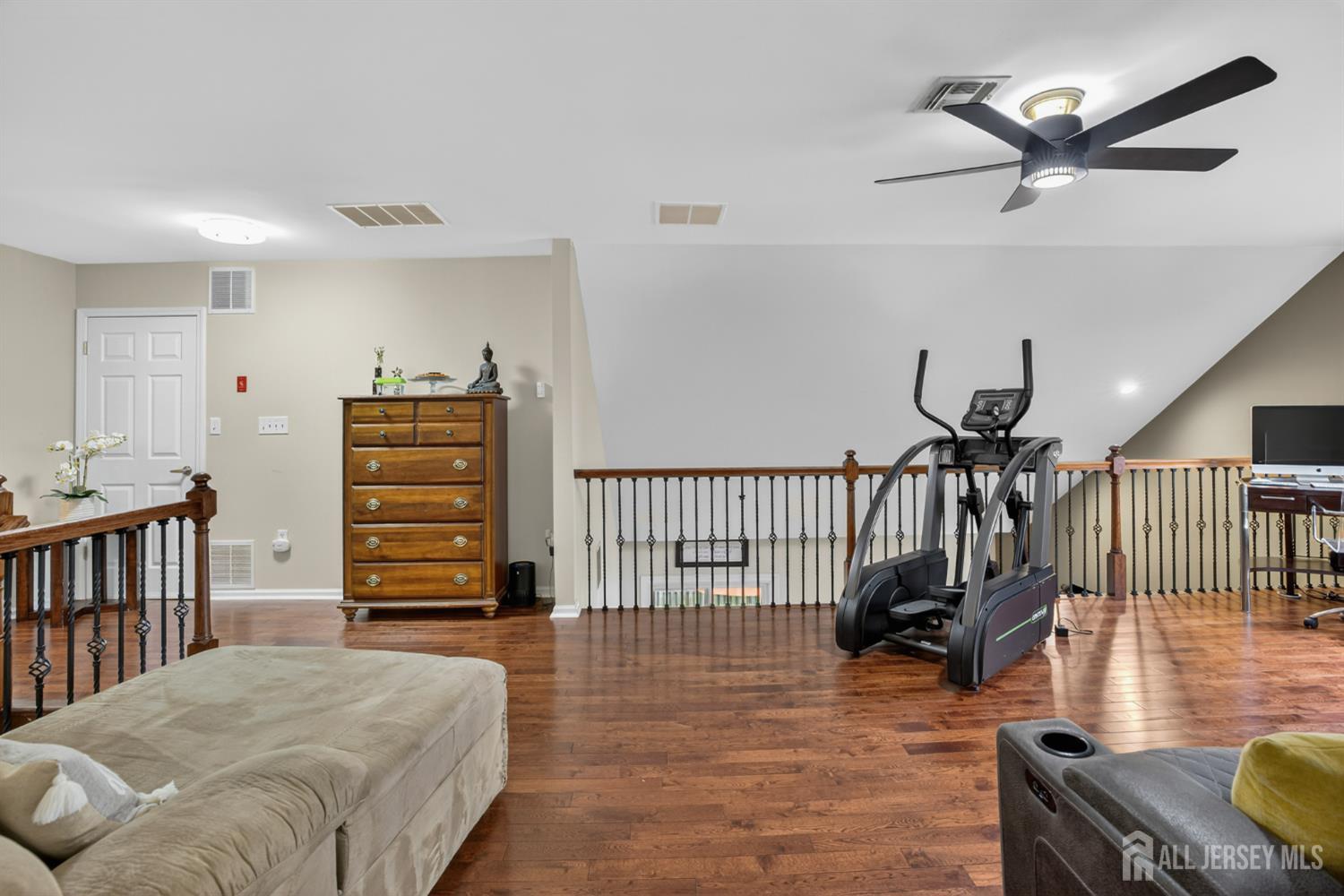 6 George Russell Way Clifton, NJ 07013 - Photo 31 of 45 a bedroom with furniture and wooden floor