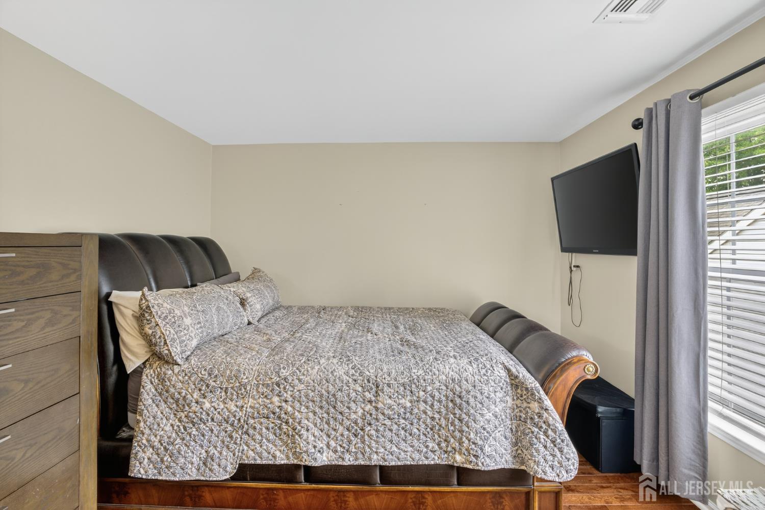 6 George Russell Way Clifton, NJ 07013 - Photo 35 of 45 a bedroom with a bed and flat screen tv