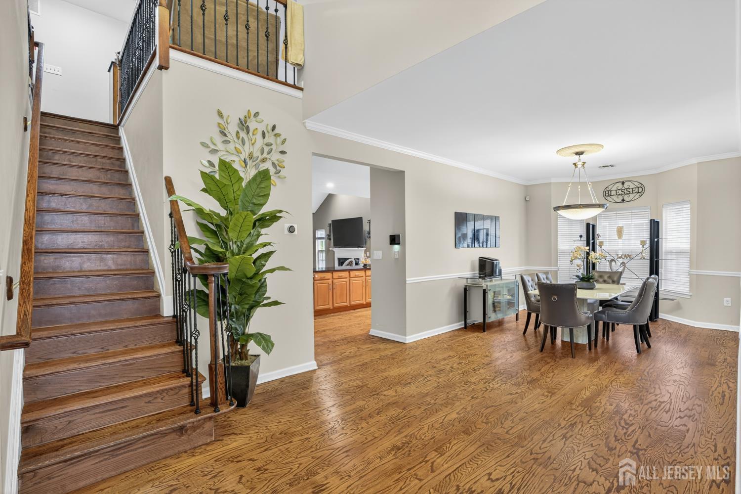 6 George Russell Way Clifton, NJ 07013 - Photo 9 of 45 a dining room with furniture potted plants and wooden floor
