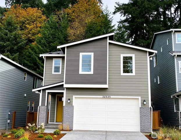a front view of a house with trees