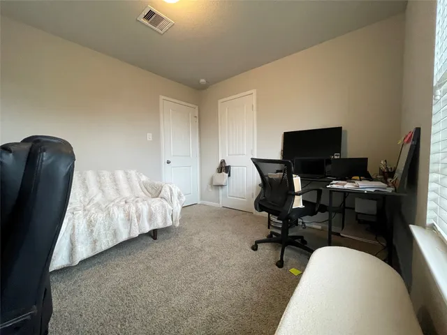a view of a workspace with furniture and a chair