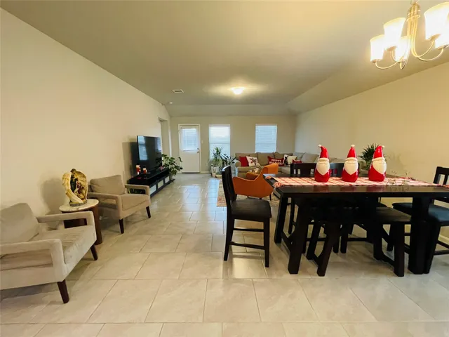 a view of a dining room with furniture and chandelier