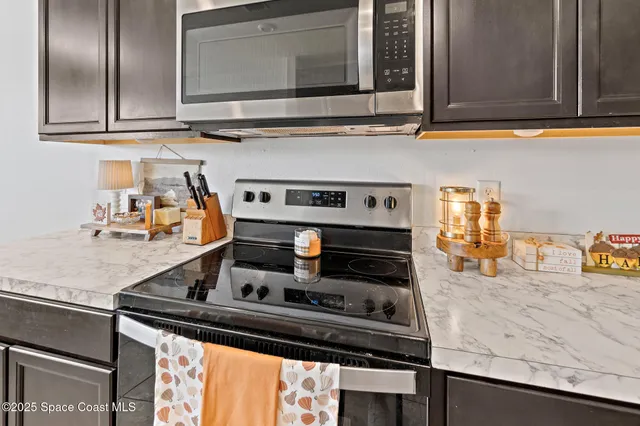 a kitchen with granite countertop a stove and a sink