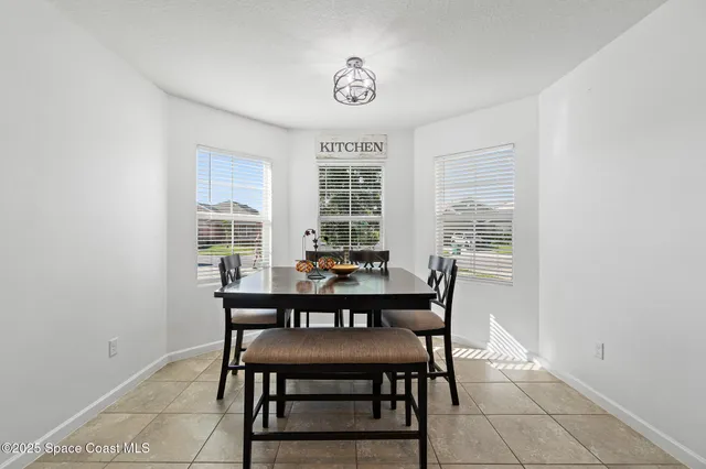 a dining room with a wooden table and chairs
