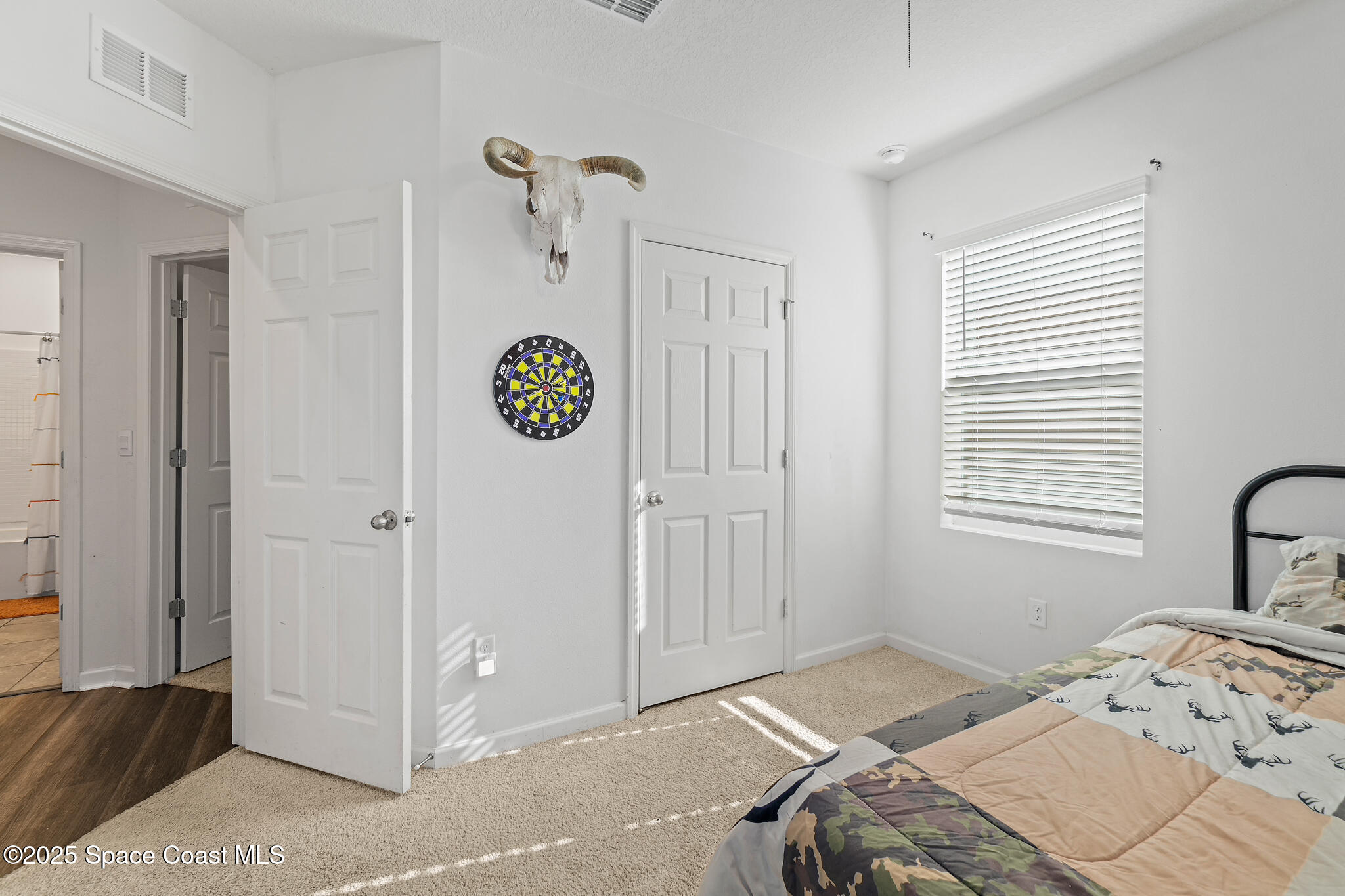 3259 Burrowing Owl Mims, FL 32754 - Photo 23 of 40 a bedroom with a bed and a window