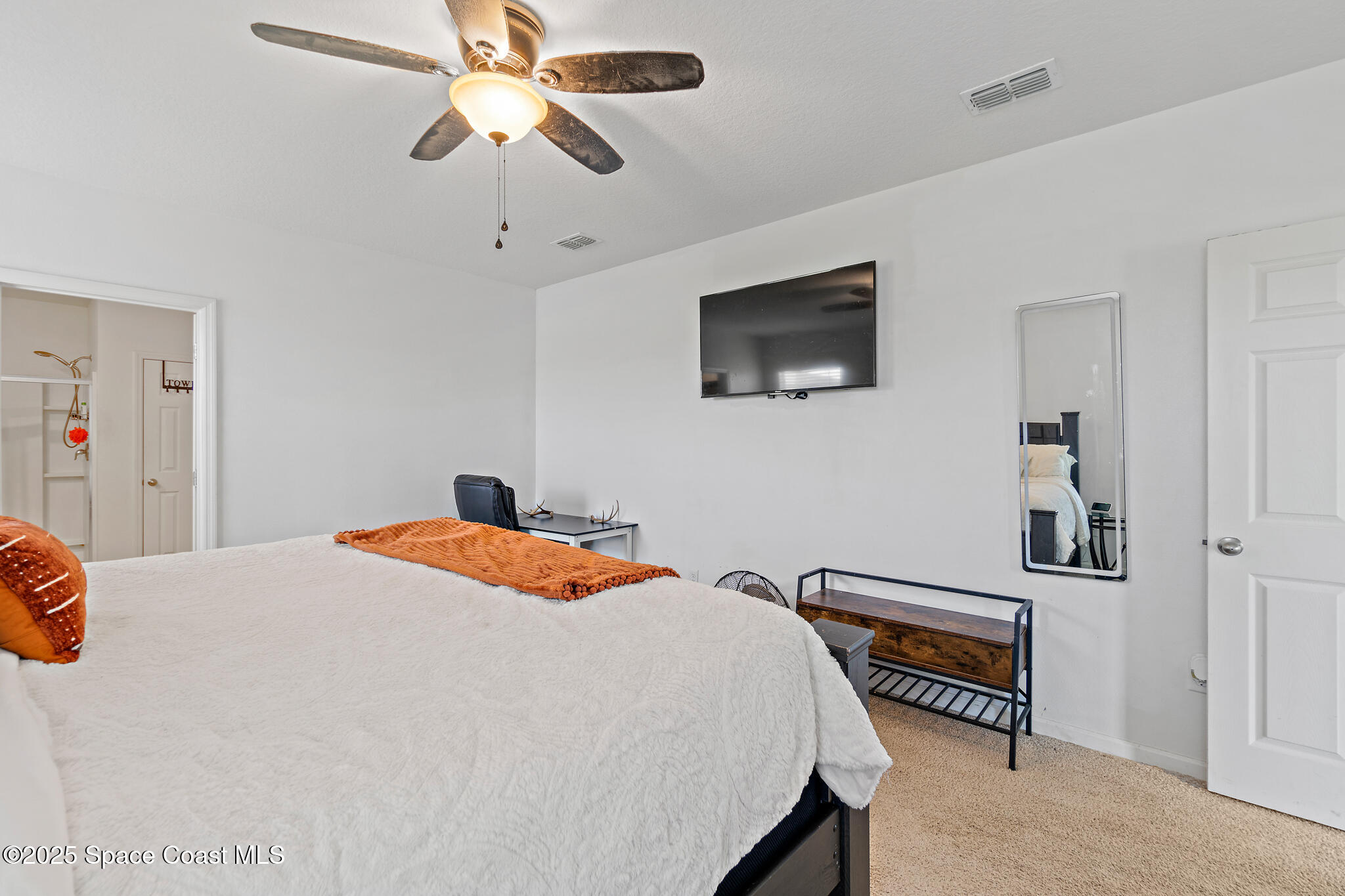 3259 Burrowing Owl Mims, FL 32754 - Photo 25 of 40 a bedroom with a bed and a chandelier