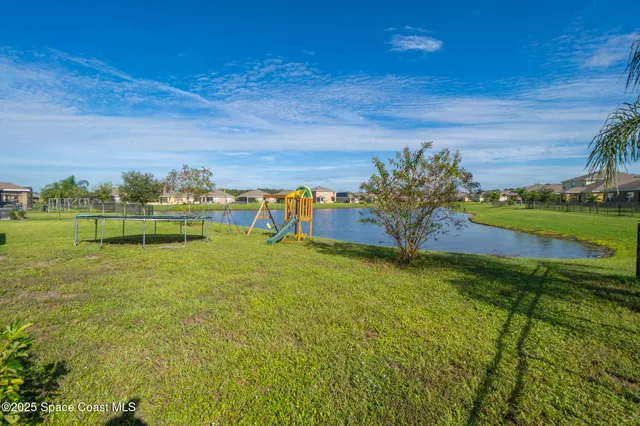 a view of a garden with a building in the background