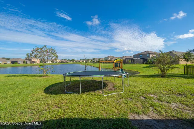 a view of a swimming pool with a yard
