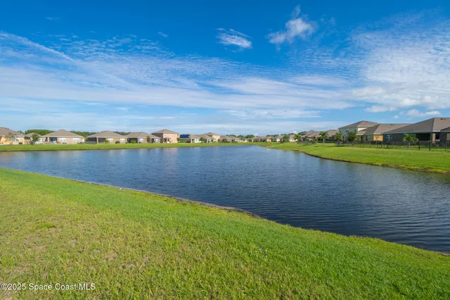 a view of a lake with houses in the back