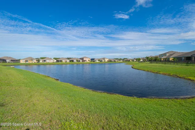 a view of a lake with houses in the back