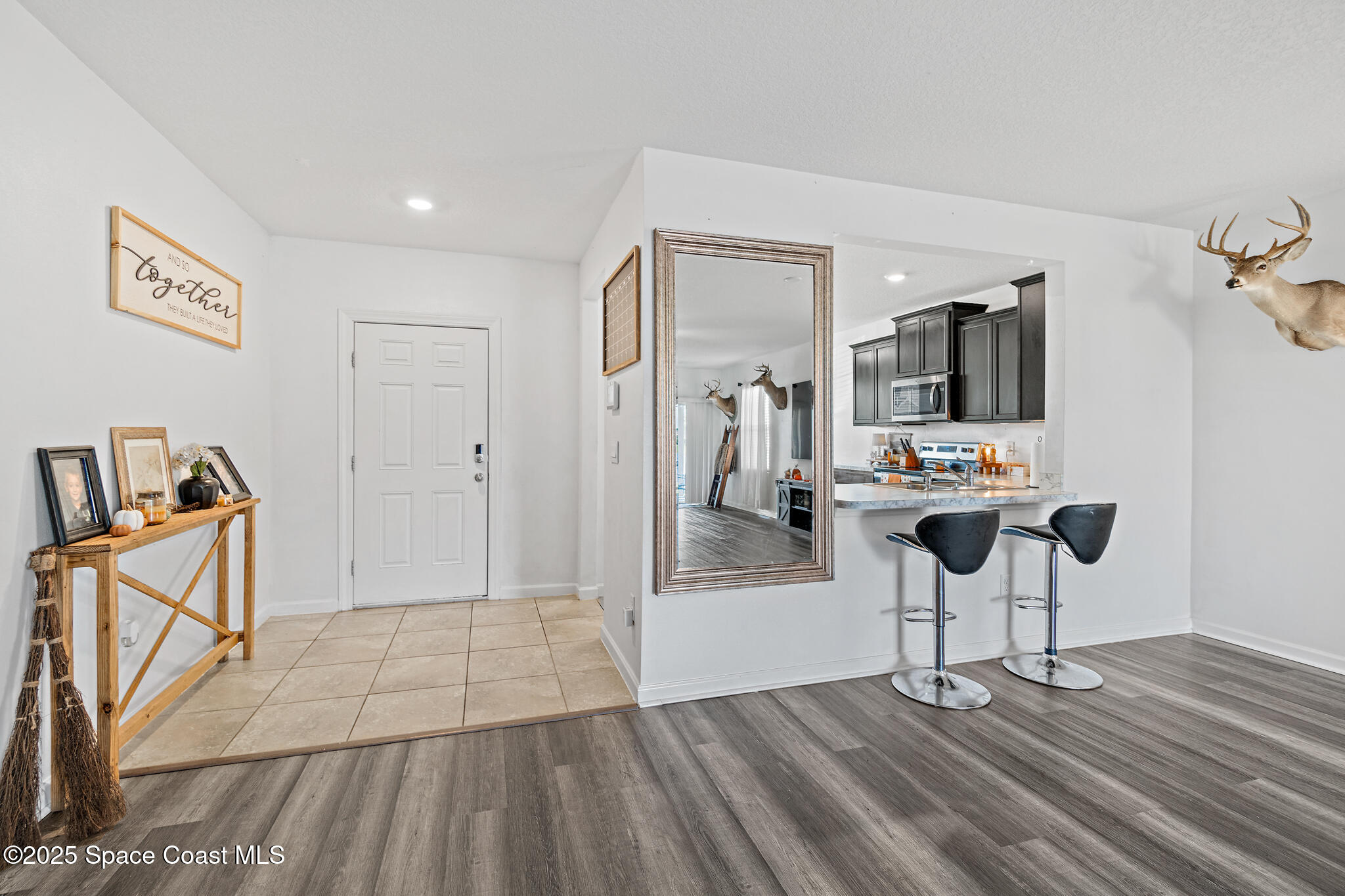 3259 Burrowing Owl Mims, FL 32754 - Photo 6 of 40 a view of kitchen with furniture and flat screen tv