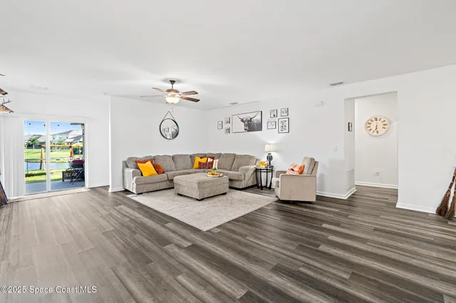 a living room with furniture and wooden floor