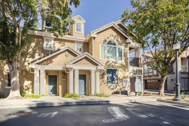 a view of a brick house with many windows