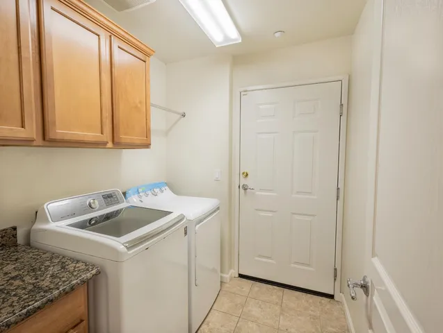 a utility room with sink washer and dryer