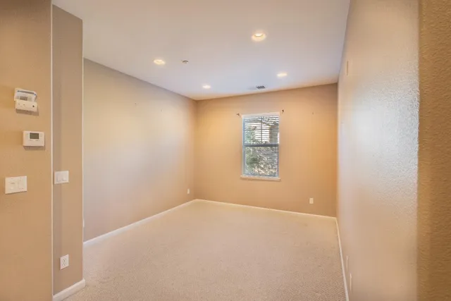 a view of a big room with windows and closet