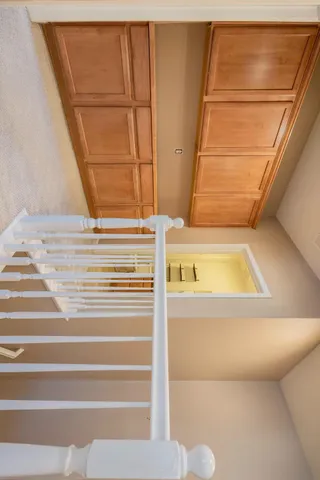 a view of walk in closet with empty racks