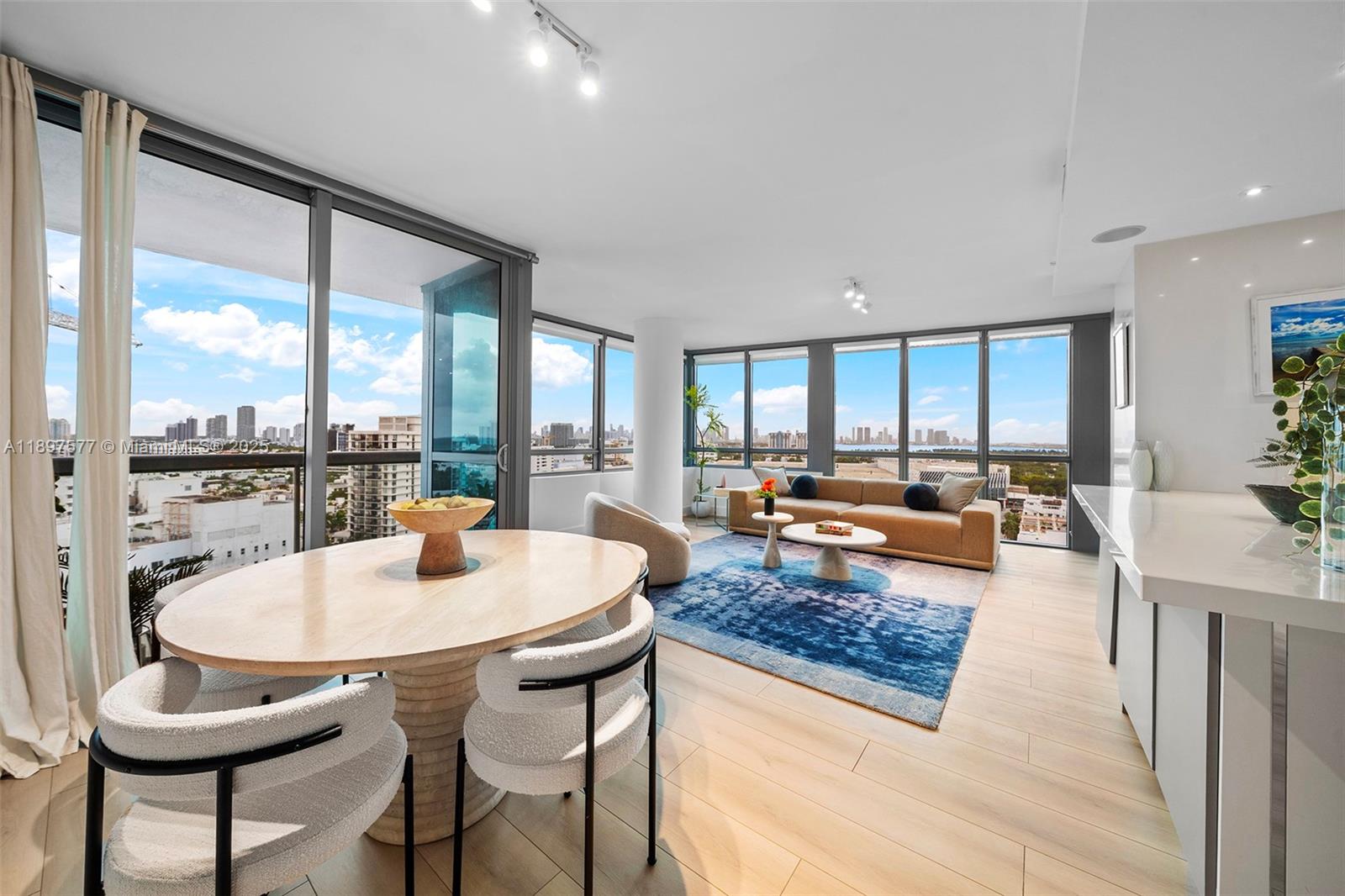 101 20th Street, Unit 2002 Miami Beach, FL 33139 - Photo 13 of 40 a living room with dining table and a large window