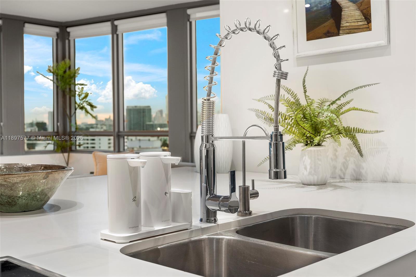 101 20th Street, Unit 2002 Miami Beach, FL 33139 - Photo 16 of 40 a kitchen with a sink and a potted plant