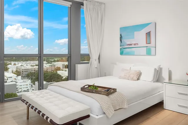 a bedroom with a large bed and a large window