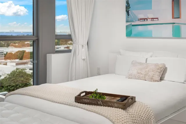 a bedroom with a bed and window