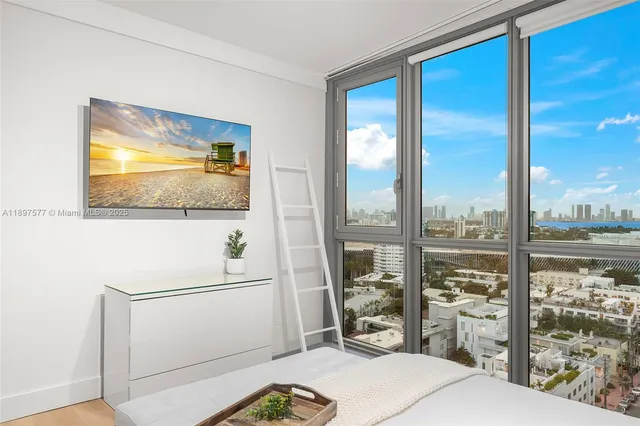 a room with a bed and a flat screen tv