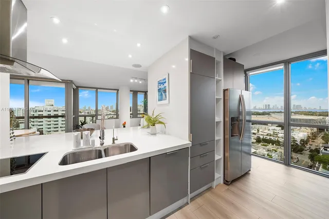a kitchen with counter top space a sink cabinets and stainless steel appliances